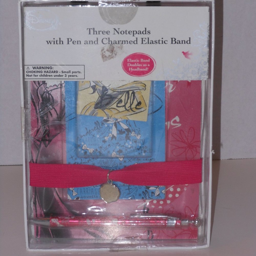 THREE NOTEPADS WITH PEN AND CHARMED ELASTIC BAND